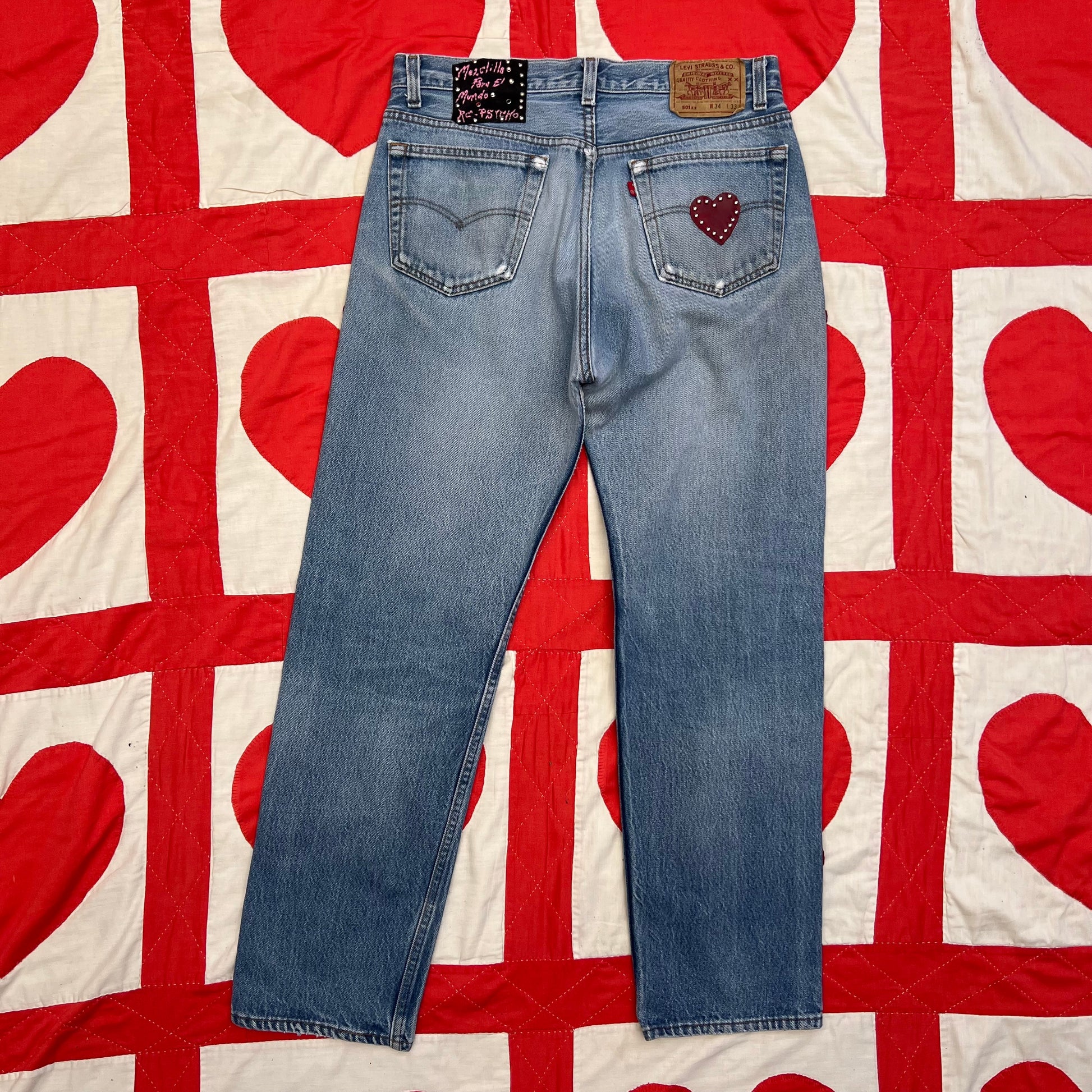 Back of Levi’s with a red leather heart on the back of right pocket 