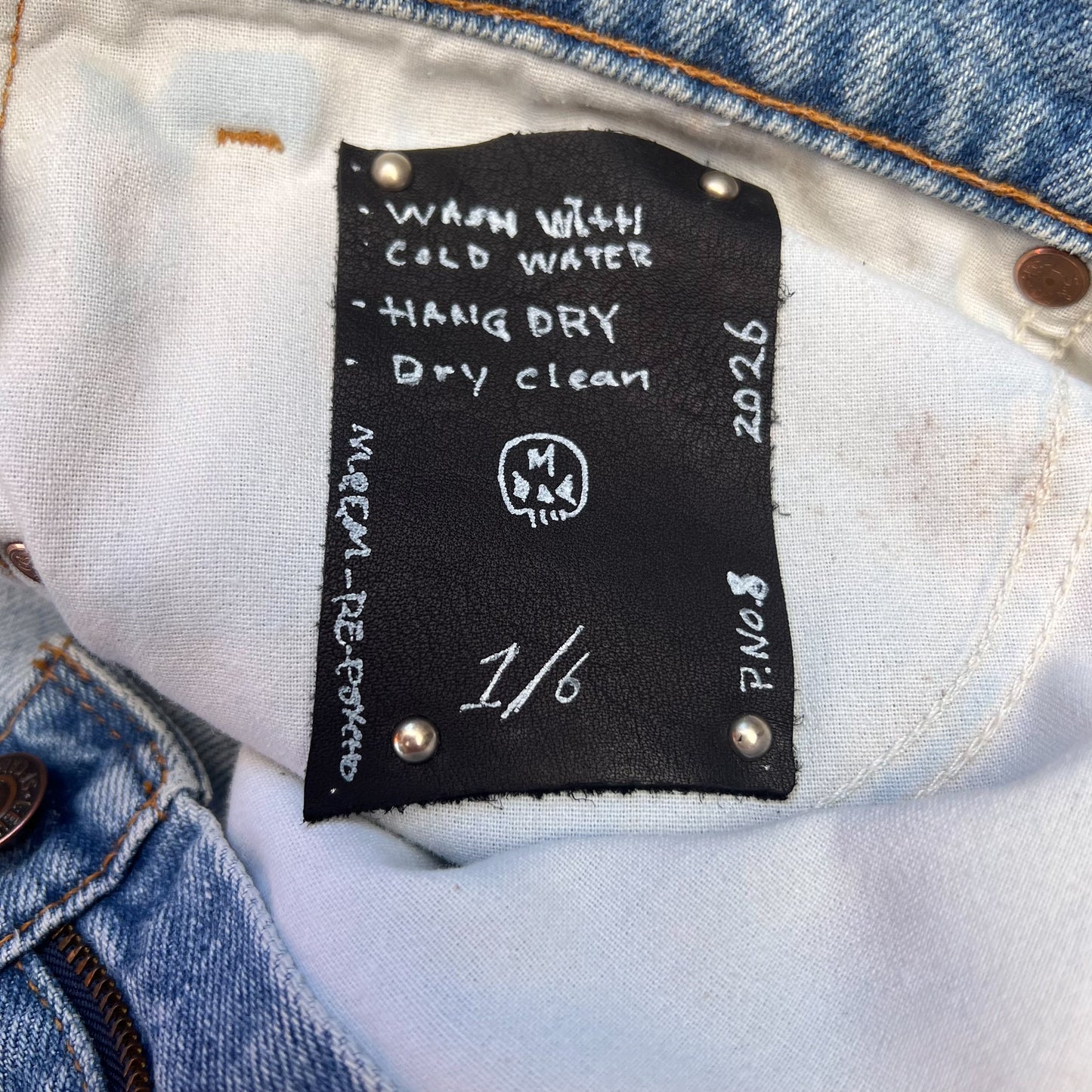 Custom leather care tag that is placed inside the jeans.