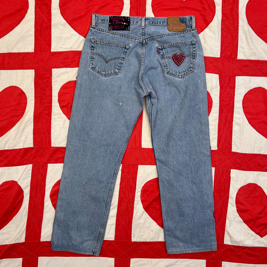 Second photo shows the back of the jeans; Custom vintage Levi’s with cut out red leather hearts on each side of the legs.