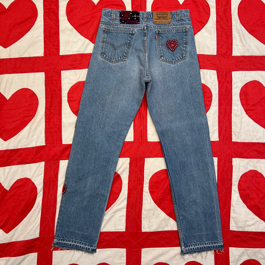 Second photo show Custom vintage Levi’s with cut out red leather hearts on each side of the legs. With red leather heart on the back right pocket.